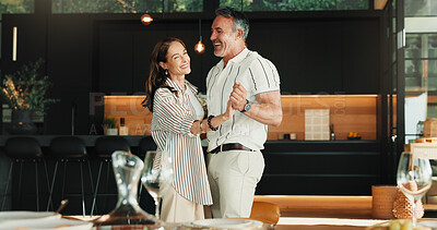 Buy stock photo Laughing, dance and mature couple in house for romantic commitment, holding hands and smile together. Happy man, woman and moving to music for marriage connection, funny partner or support for love