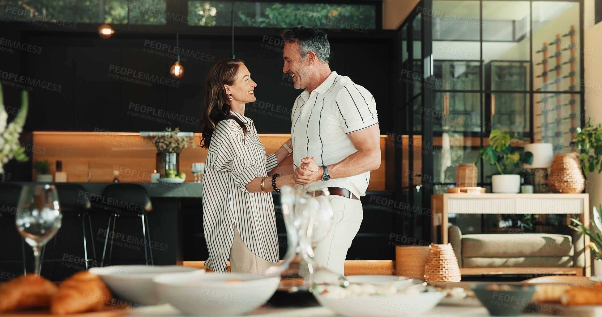 Buy stock photo Smile, dance and couple in home for love with romantic commitment, holding hands or bonding together. Happy mature man, woman and moving with music for marriage connection, partner support and care
