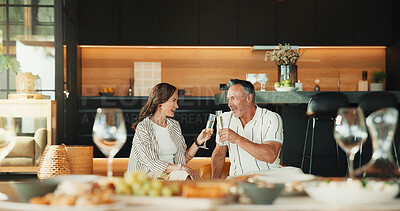 Buy stock photo Couple, home and smile with champagne, cheers and bonding with partner in lounge and relax together. Relationship, anniversary and happy mature people with alcohol, celebration and toast in house