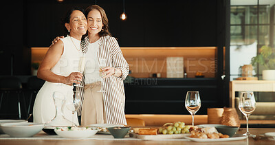 Buy stock photo Friends, hug and meal in home with champagne, bonding together and visit for connection on weekend. Happy, mature women and embrace by dining table with lunch food, alcohol drink and friendship.
