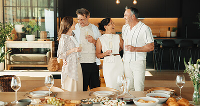 Buy stock photo Celebration, hug or friends in home with champagne, bonding or happy moment with reunion meal. Smile, drink or mature people with dinner together, party connection or good time with social gathering.