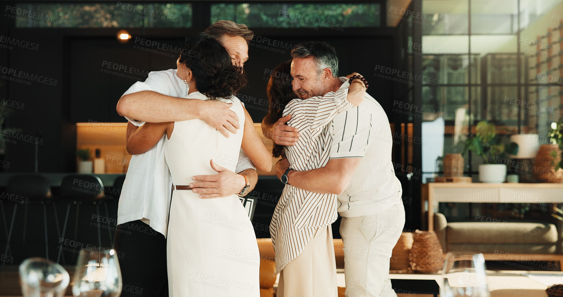 Buy stock photo Mature, people and love with hug in home for reunion, welcome or social gathering together. Group, couple of friends and embrace with support or trust for bonding celebration, event or party in house