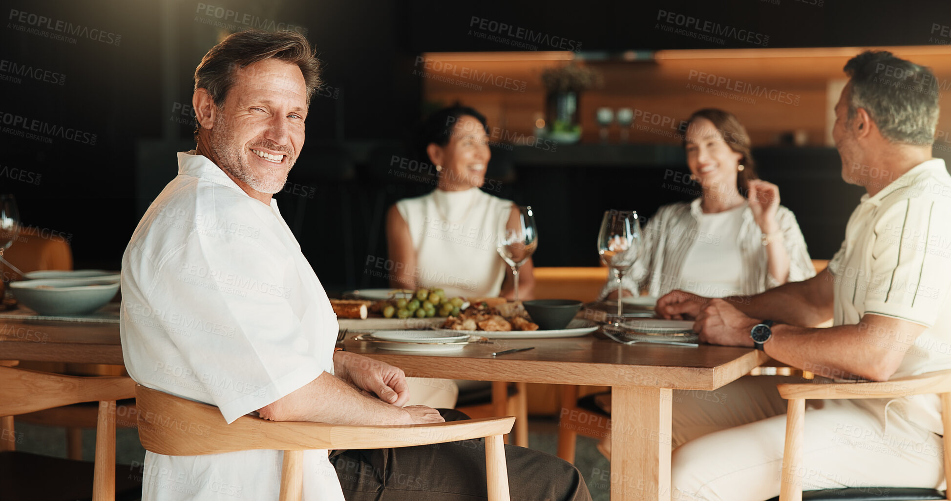 Buy stock photo Celebration, friends or man in home with portrait, satisfaction or happy moment with dinner bonding. Wellness, smile or mature host with meal, reunion party or positive attitude at social gathering.