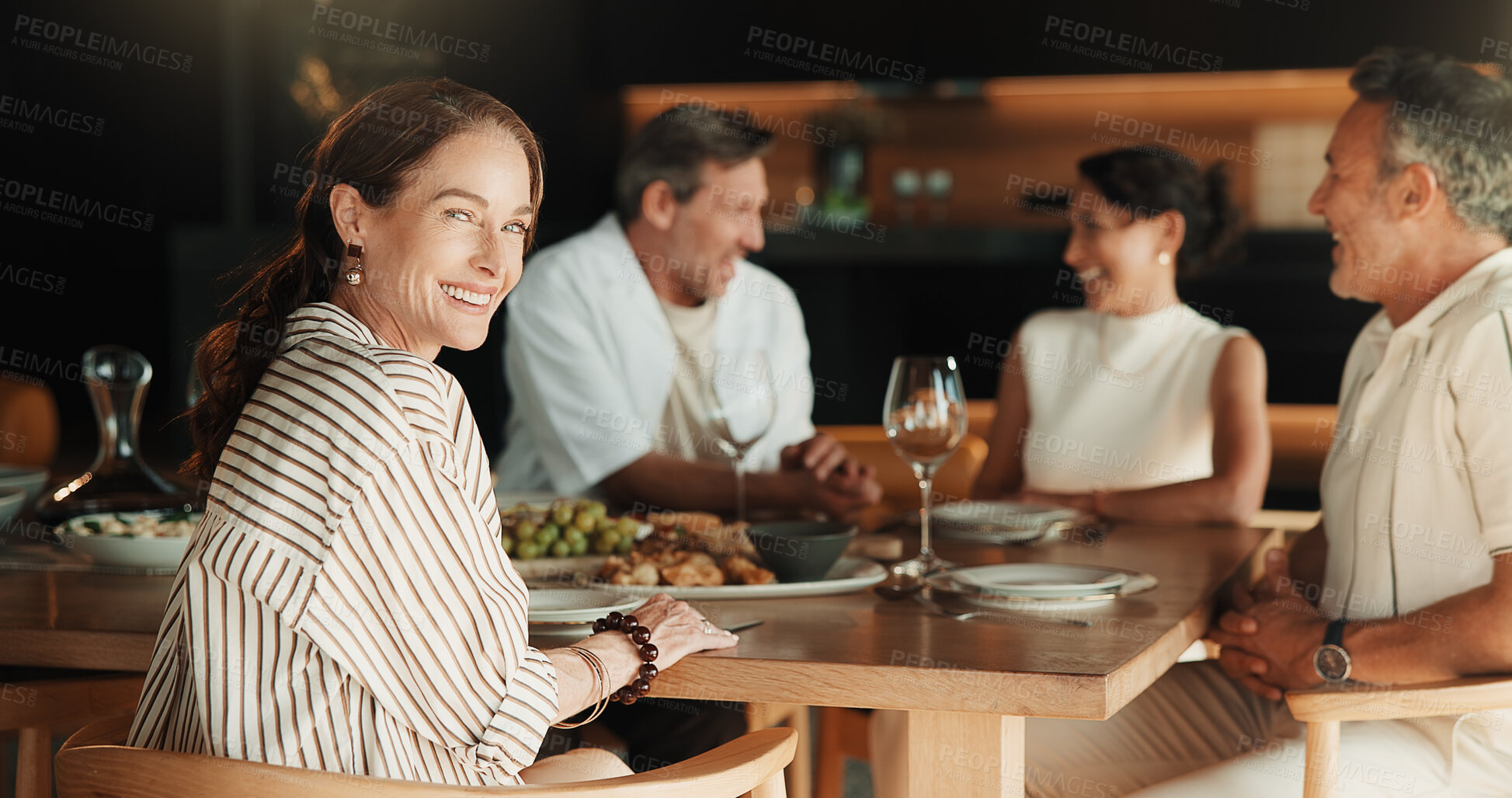 Buy stock photo Celebration, friends or woman in home with portrait, satisfaction or happy moment in dinner bonding. Wellness, smile or mature host in lounge with meal, reunion party or good time at social gathering