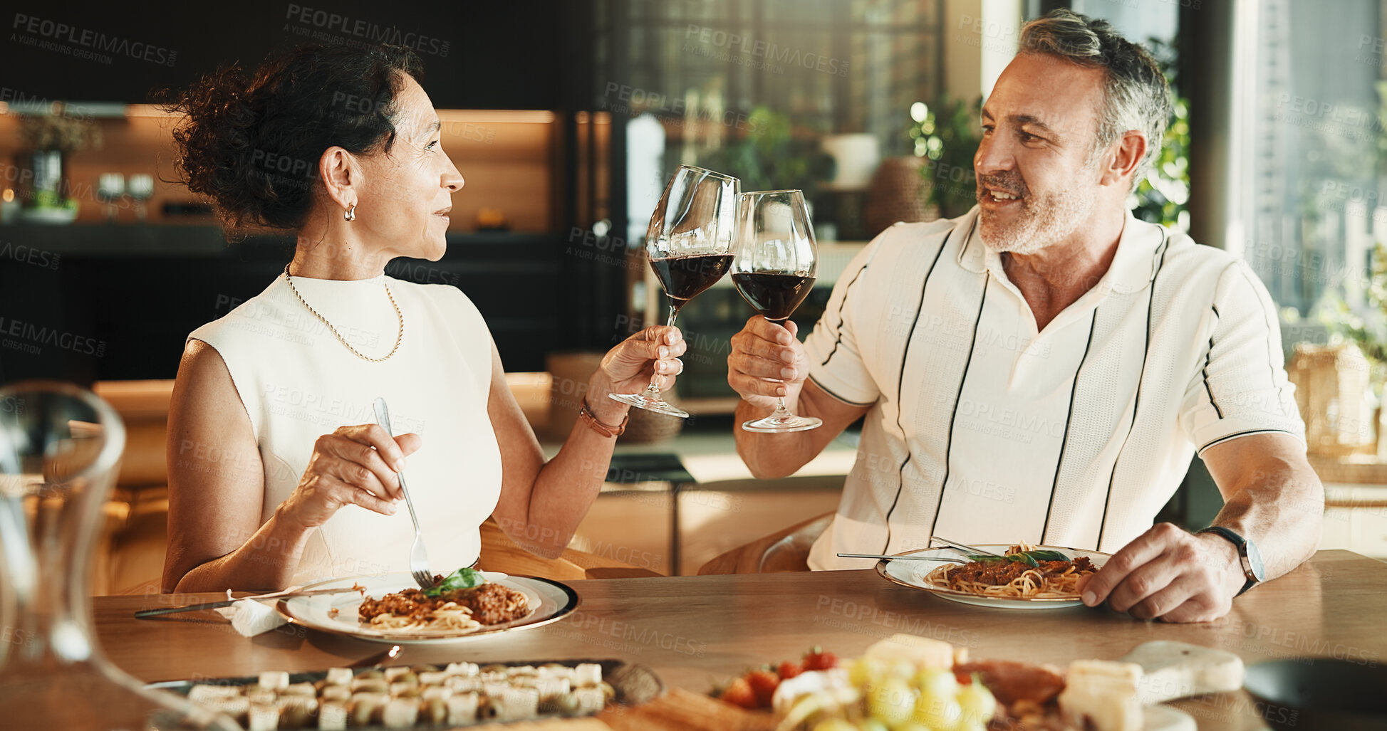 Buy stock photo Couple, food or toast with wine for love, relationship milestone or anniversary meal in home. Happy man, mature woman and cheers with drink for appreciation, marriage care and lunch date with alcohol