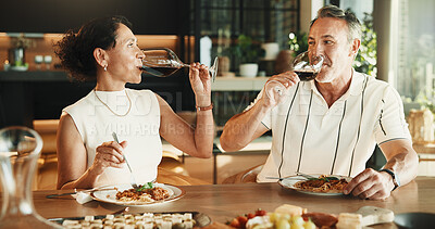 Buy stock photo Couple, food and drinking with wine for love, relationship milestone and anniversary meal in home. Happy woman, mature man and eating with alcohol, marriage bonding and lunch date with connection