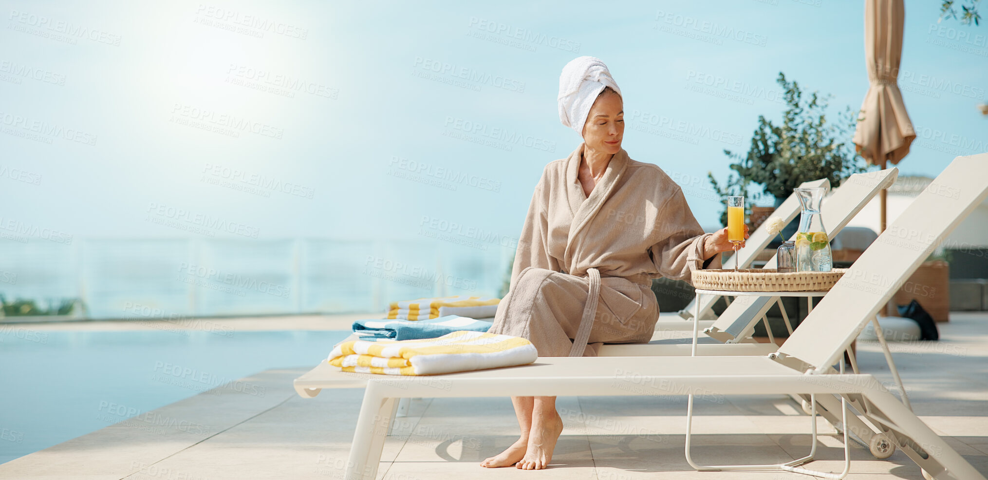 Buy stock photo Woman, relax and drink at resort for travel, tanning and summer holiday for weekend unwind. Space, mature person and orange juice at retreat for sunbathing, calm morning and stress relief on vacation