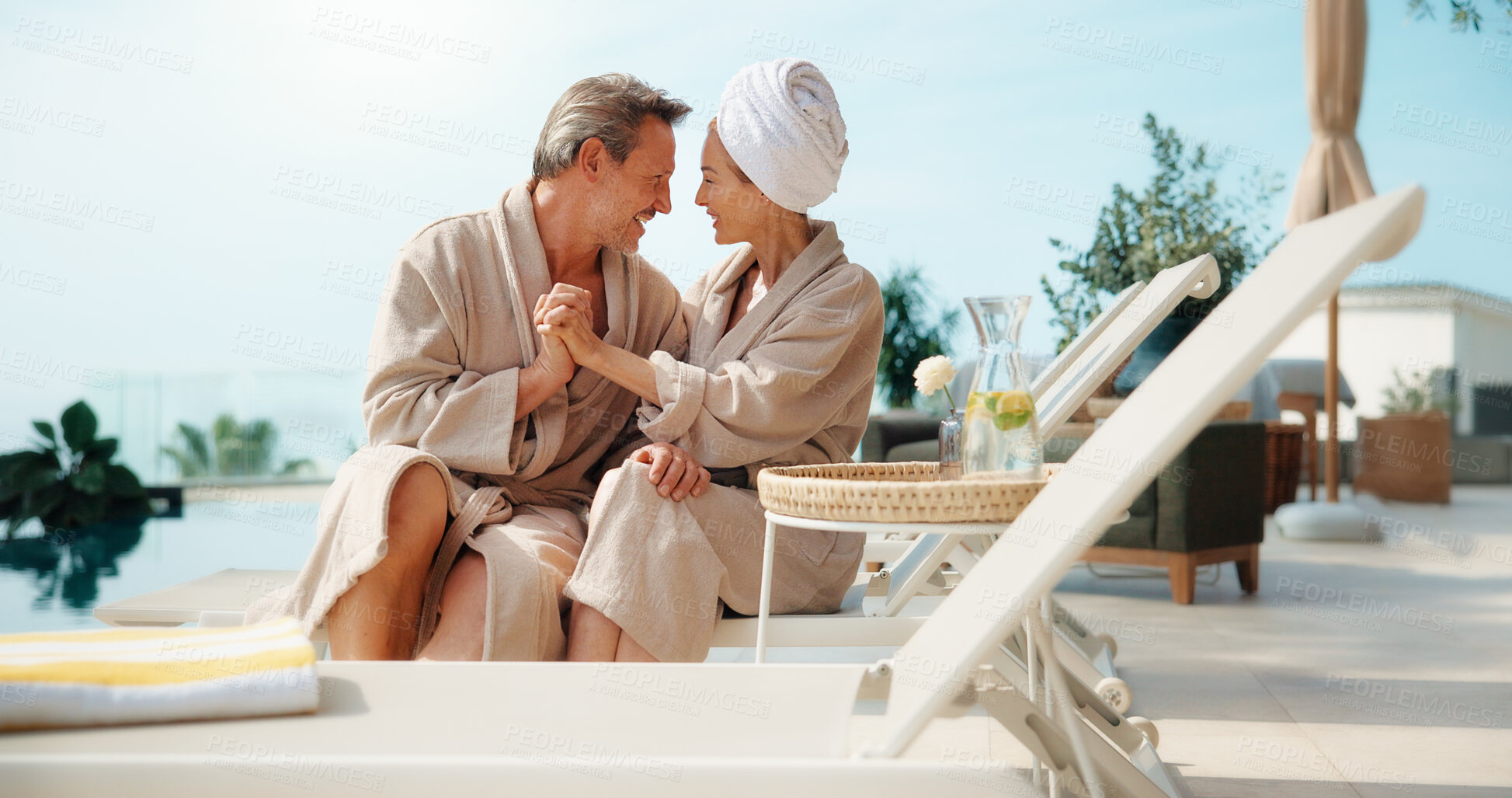 Buy stock photo Couple, relax and holding hands at resort with smile, love and bonding together on summer holiday. Space, mature people and happy at retreat with romance, partner affection and fresh air on vacation
