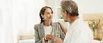 Couple, hotel and cheers with champagne for honeymoon, holiday getaway or accommodation together. Mature, man and woman with smile, toast or drink in luxury suite for weekend trip or date in resort