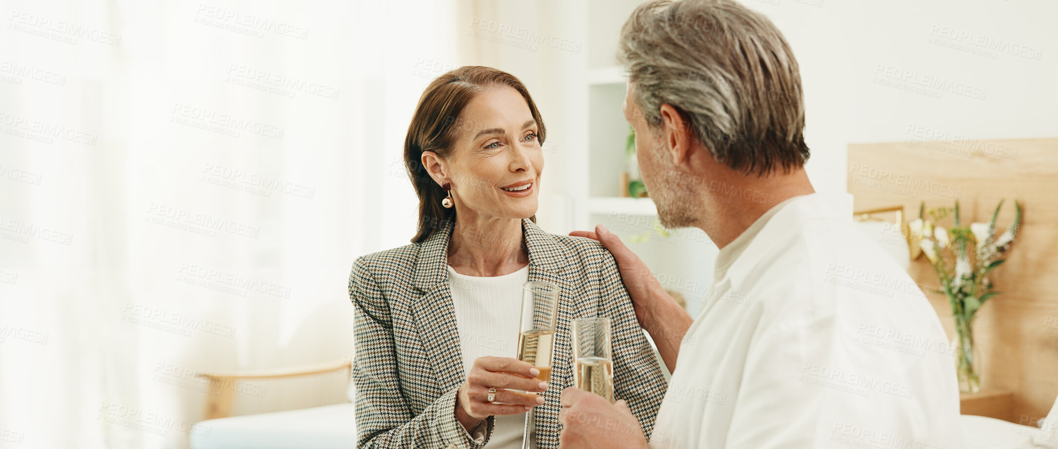 Buy stock photo Couple, hotel and cheers with champagne for honeymoon, holiday getaway or accommodation together. Mature, man and woman with smile, toast or drink in luxury suite for weekend trip or date in resort