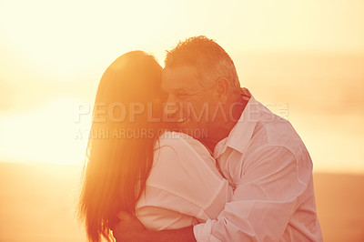 Buy stock photo Happy, sunset and couple with hug by beach for bonding, love and care on seaside vacation. Date, summer and man embracing woman by ocean or support in marriage on holiday, weekend trip or travel.