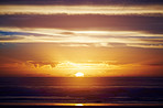 Landscape, ocean and sky with sunset outdoor for summer, holiday and seascape in nature. Horizon, environment and sunshine for sea, destination and water scenery for weekend break and travel or trip