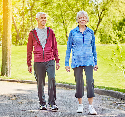 Buy stock photo Elderly, happy couple and walking in park for health, retirement or outdoor wellness together. Senior, man and woman with smile for physical activity, mobility or exercise on sidewalk in neighborhood