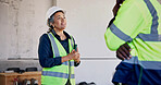 Supervisor, woman and talk at construction site with team, smile or good news for civil engineering. Happy project manager, people and feedback in building with engineer, property development or plan