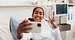 Happy, girl or selfie with peace sign in hospital bed for medical treatment, photography or memory. Child, patient or kid with smile or emoji for social media app, capture moment or picture in clinic