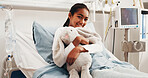 Smile, hospital bed and child with toy, healthcare service and recovery with inpatient care. Pediatric ward, hug stuffed animal and portrait of happy girl with medical healing, resting and wellness