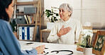 Woman, senior and chest pain with doctor in clinic for medical consultation or health diagnosis. Female people, healthcare worker or listening with elderly patient for asthma or illness in office