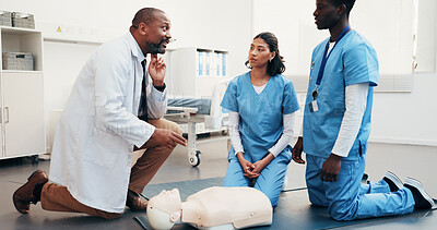 Buy stock photo Medical, team and doctor demonstration for cpr training, artery location and technique with dummy. People, physician and nurses with mannequin, check carotid pulse and explain life saving procedure