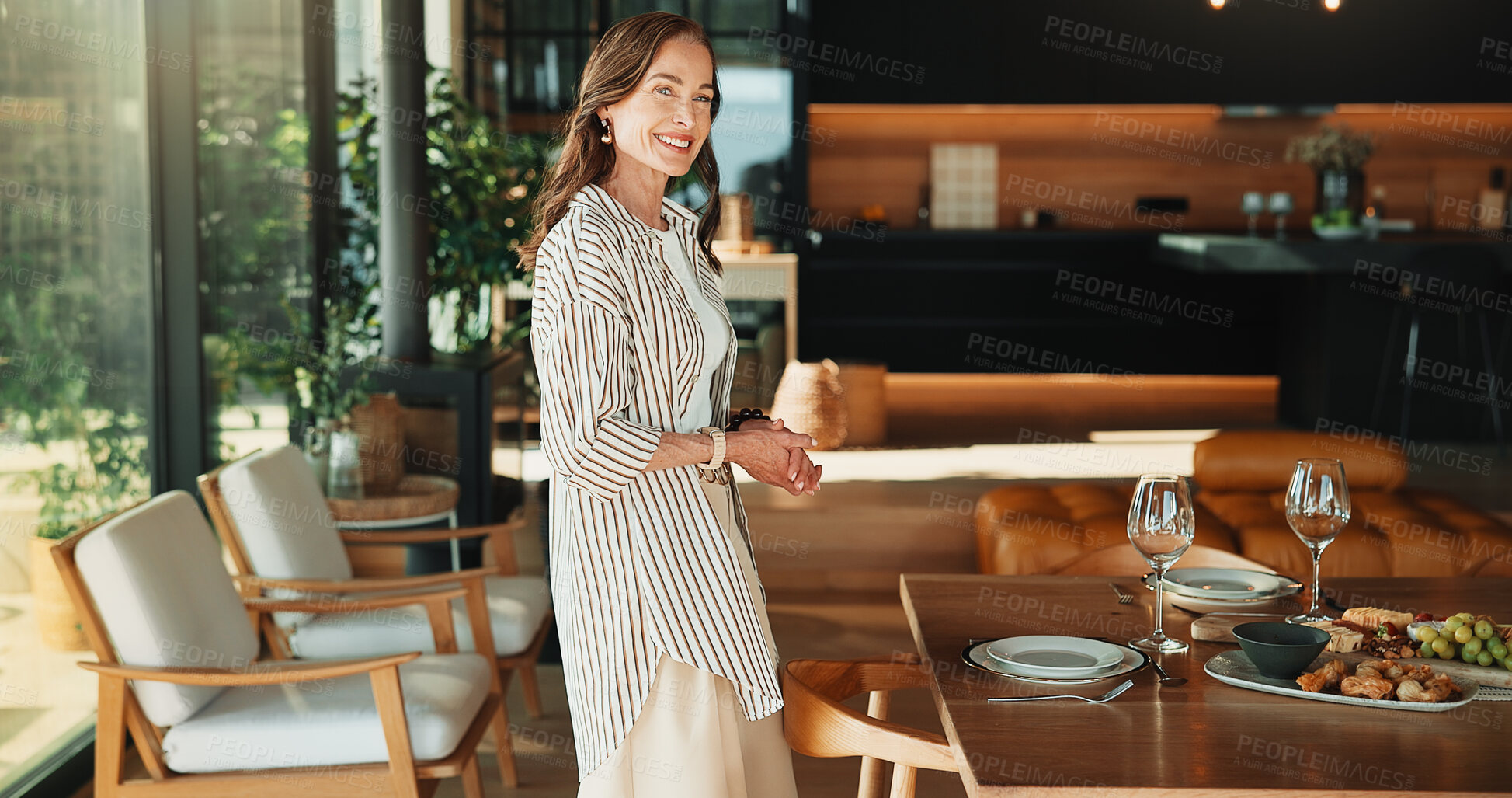 Buy stock photo Portrait, woman and hosting lunch in home with smile, weekend break and pride for dining table setup. Happy, mature person and preparation in house with food, afternoon meal and waiting for guest.