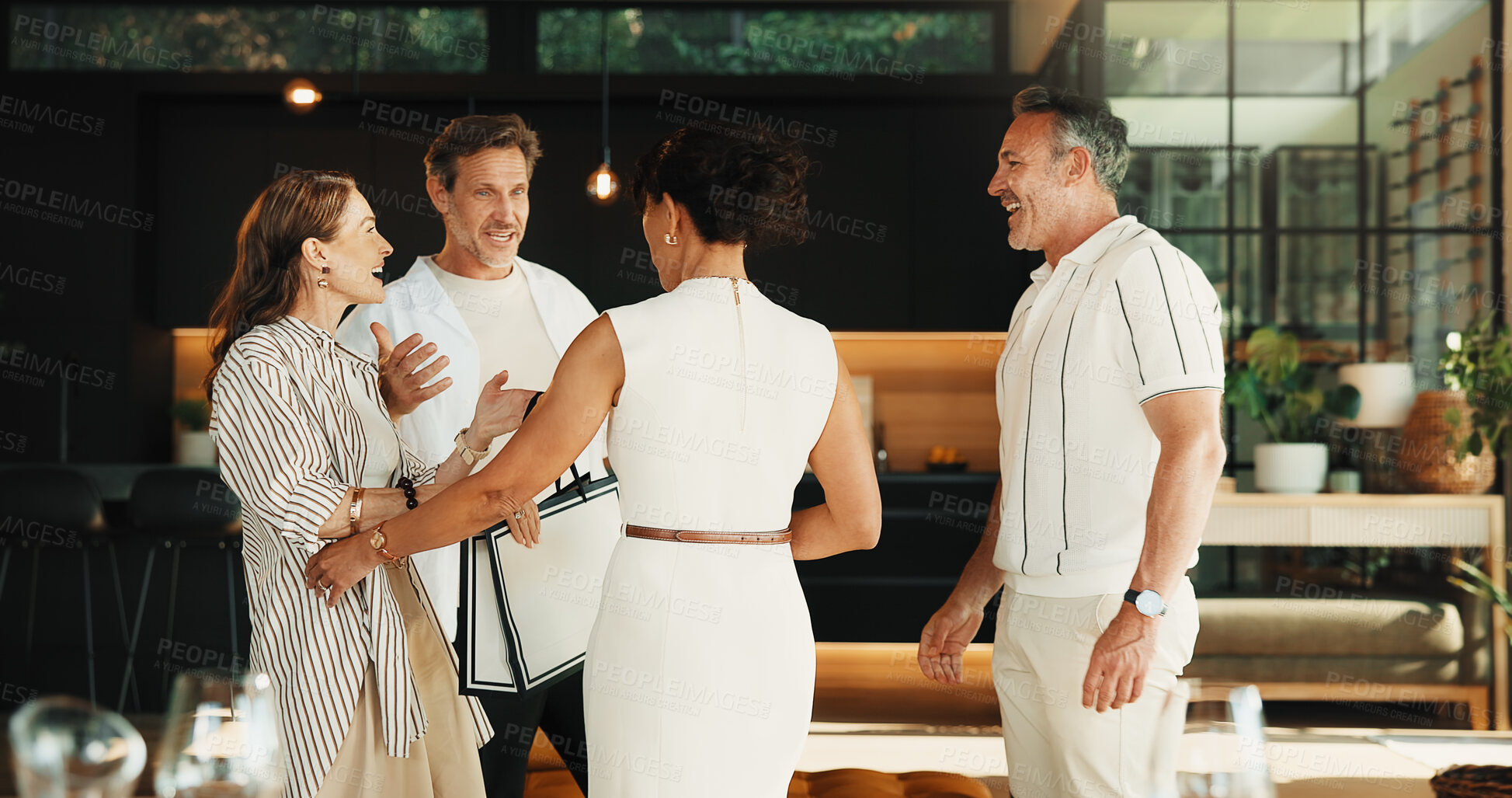 Buy stock photo Smile, friends and hug at house with gift, welcome and celebration of birthday party in lounge. Happy, mature people or embrace in home with present, greeting guest and gratitude for special occasion
