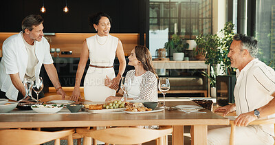Buy stock photo Friends, discussion and laughing at dinner party in house, bonding and social gathering on weekend. Happy mature people, together and conversation with meal, connection and reunion on break in home