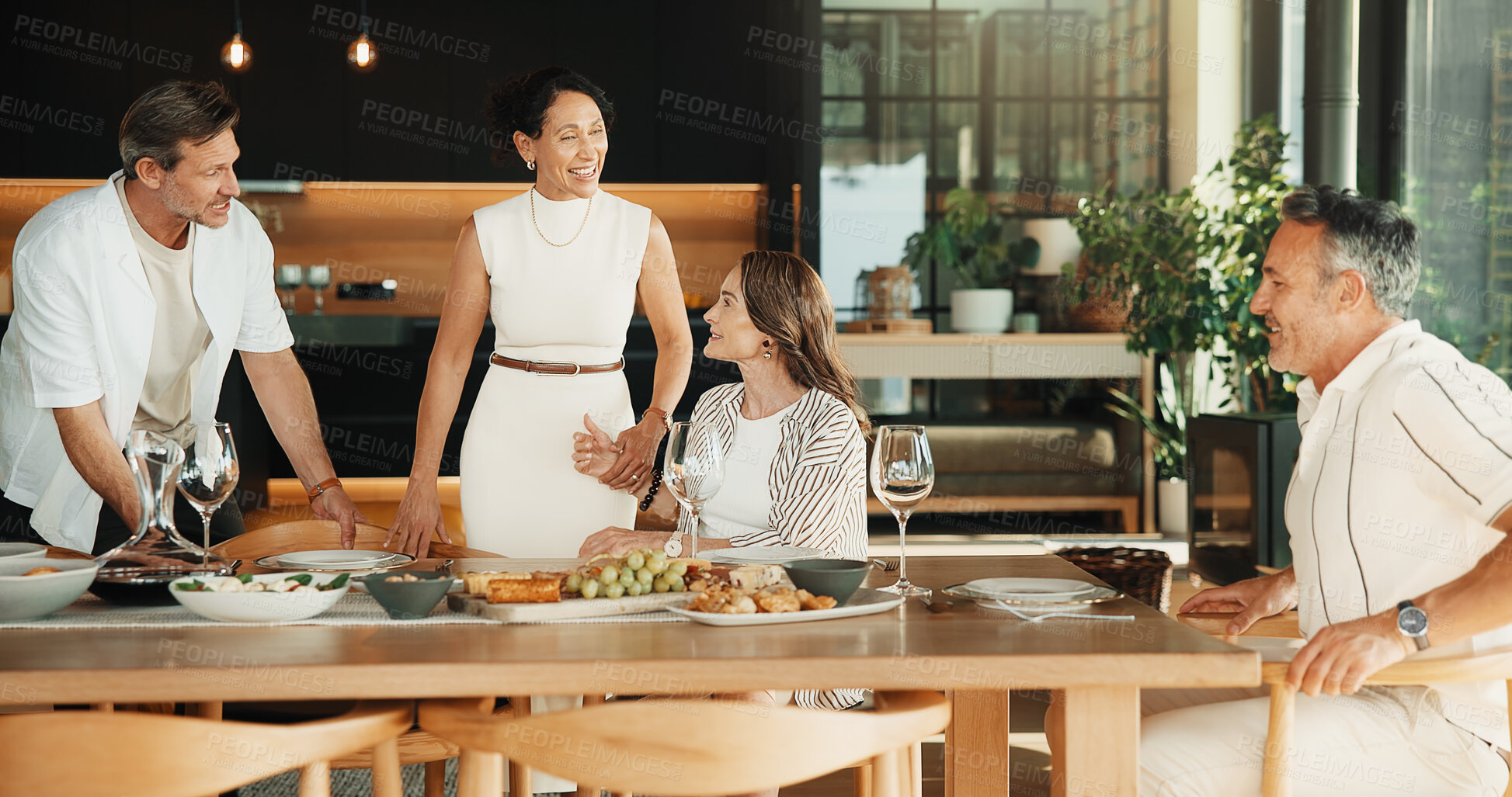 Buy stock photo Friends, discussion and laughing at dinner party in house, bonding and social gathering on weekend. Happy mature people, together and conversation with meal, connection and reunion on break in home