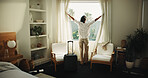 Window, curtain and woman with travel suitcase in hotel for holiday getaway or vacation trip. Female person, relax and awake with sunshine for weekend or morning stay in luxury bedroom or resort