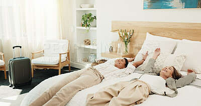 Buy stock photo Happy, women and relax with suitcase in bedroom hotel for holiday, weekend getaway or vacation. Female people, lying or accommodation with smile in bed for break, rest or bonding together in resort