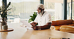 Remote work, home and black man with document for financial information, budget planning or review. Freelancer, mature person or advisor with notebook for investment, reading paperwork or tax records