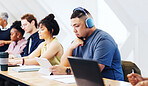 Man, student or headphones in class with tablet, research assignment or reading requirements. Academic, tech or online in community college for learning, video tutorial or educational platform on app
