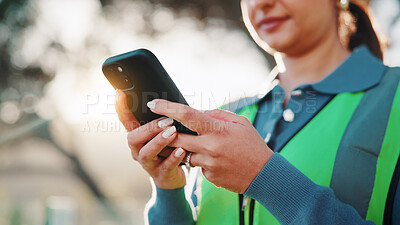 Buy stock photo Construction worker, message and hands with phone, outdoor or communication with contact on website. Low angle, property development and person with mobile, texting and project update on social media