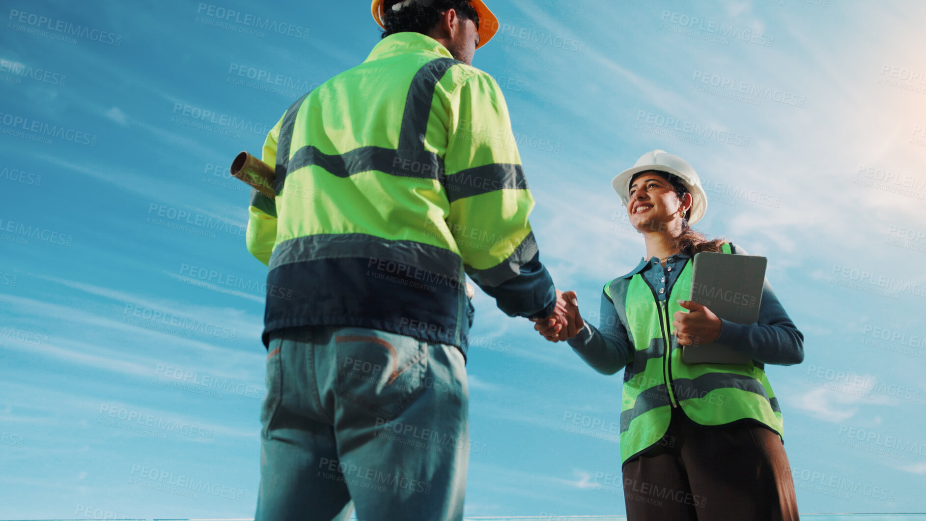 Buy stock photo Team, handshake and people with tablet on construction site, low angle or partnership for renovation. Sky, space and engineers with technology for project, collaboration and property development