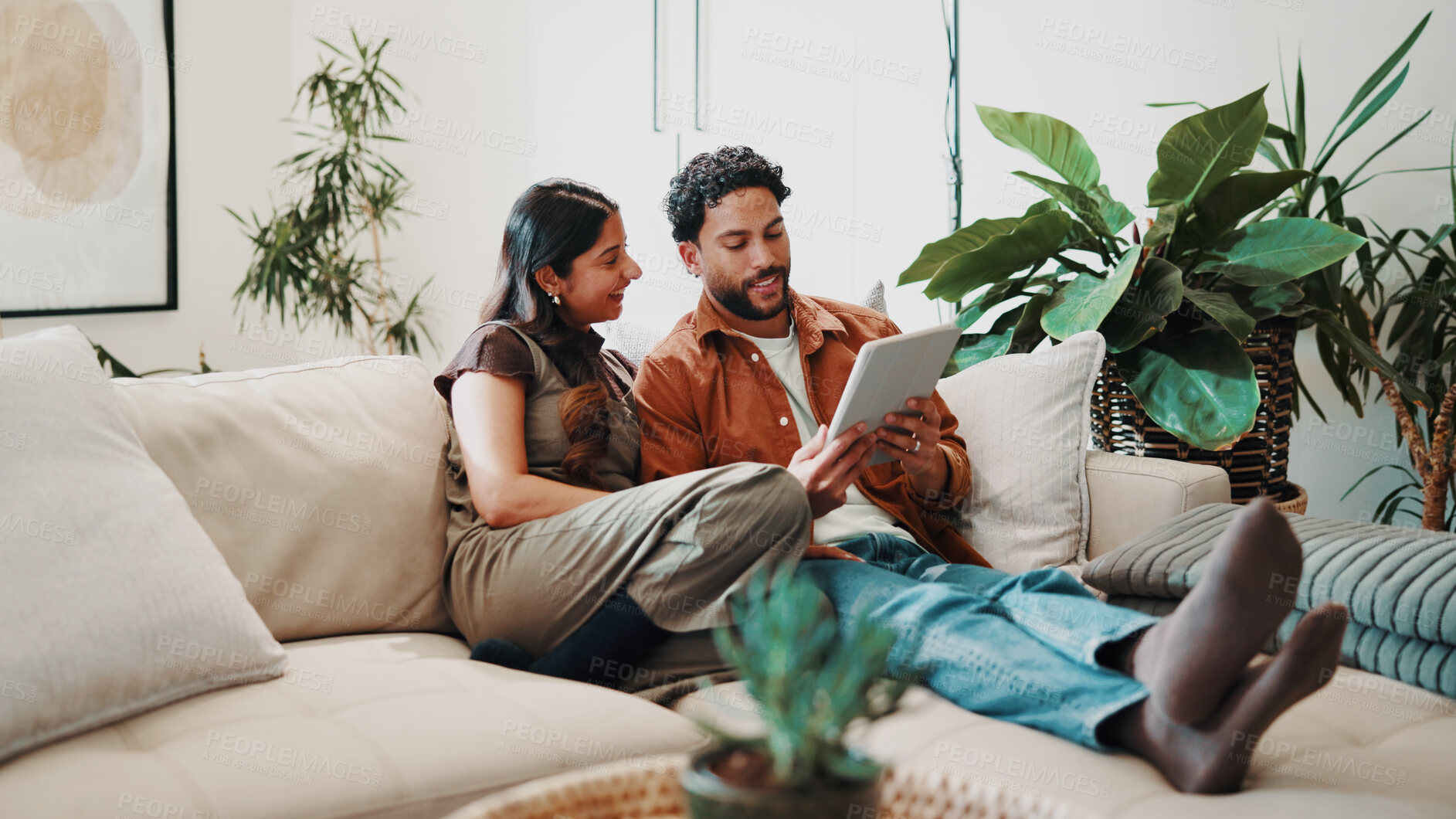 Buy stock photo Couple, relax and tablet on sofa for connectivity, bonding and quality time with streaming. Happy, together and people with digital tech in living room, film app or network with internet in home