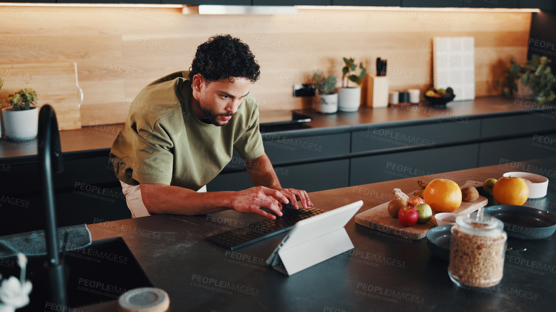 Buy stock photo Man, typing and tablet in kitchen with breakfast, healthy food or search blog for nutritional recipe. Morning, person and browsing website in home with digital tech, fruits or ask AI how to meal prep