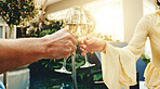 Cheers, hands and couple with champagne in resort for holiday getaway or weekend together. Man, woman or relax with alcohol, glass or toasting drink for vacation, honeymoon trip or bonding in retreat