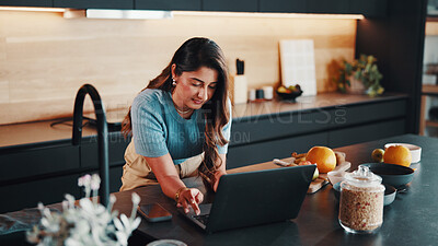 Buy stock photo Man, typing and meal prep in kitchen with laptop, food blog or search online tutorial for breakfast. Person, browsing and ingredients in home with computer, healthy recipe and planning in morning.