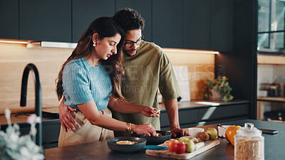 Buy stock photo Couple, breakfast and meal prep in kitchen with fruits, bonding together and nutrition for wellness. Married people, ingredients and healthy food in home with embrace, diet and assistance for recipe.
