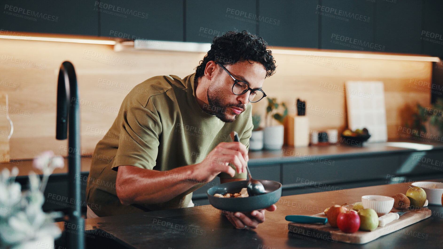 Buy stock photo Hungry, man and bowl in kitchen with breakfast, fruit and morning nutrition for gut health benefits. Person, eating and organic food in house for meal, wellness and ingredients for balanced diet.