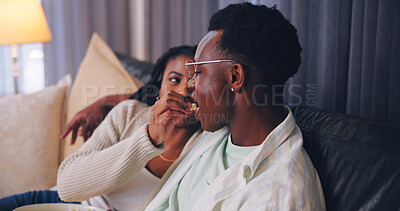 Buy stock photo Streaming, popcorn or couple in home with feeding, movie binge or watching tv on weekend break. Relax, connection or black people with snack, series subscription or romantic moment with film activity