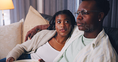 Buy stock photo Streaming, love and couple in house with snack, movie binge or watching tv on weekend break. Relax, connection or black people with popcorn, series subscription or bonding with entertainment activity