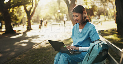 Buy stock photo Laptop, medical student and woman at park for learning, research or course module assignment. Computer, happy person and healthcare trainee on bench outdoor, education review or nurse typing report
