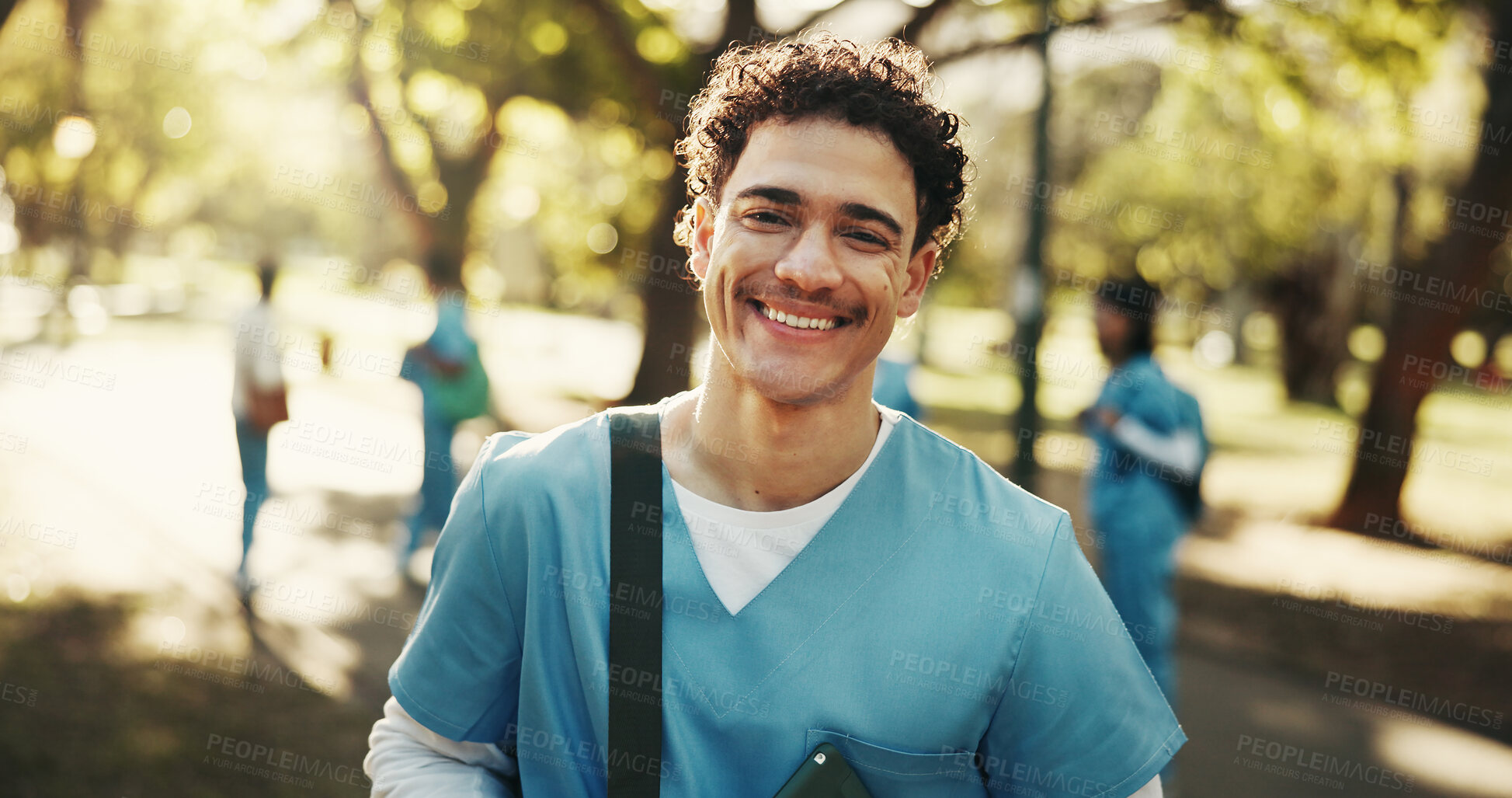 Buy stock photo Man, nurse and medical student with smile outdoor for scholarship development, wellness or portrait. Healthcare, intern and happy male person at park, residency and education at nursing school