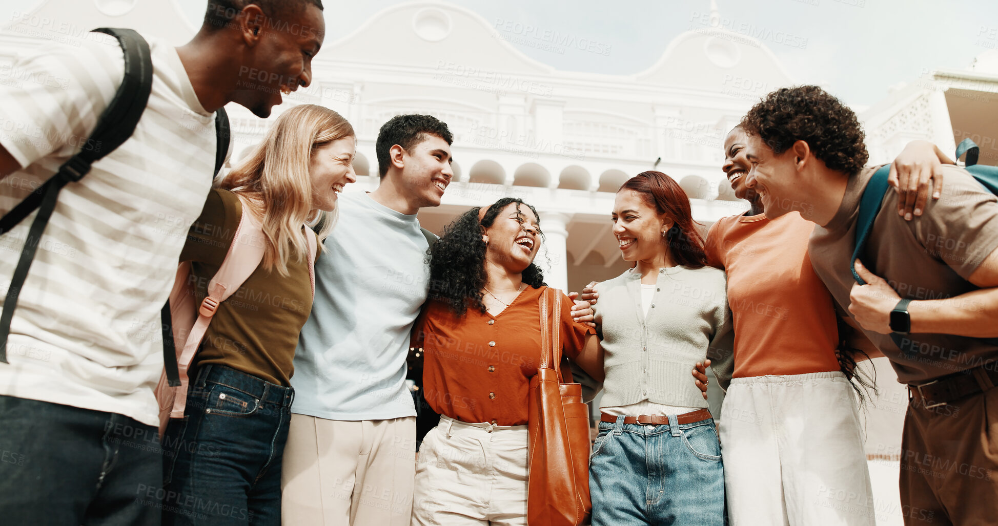 Buy stock photo Student, hug or laughing with friends in university for recess, academic break or unity on campus. People, community or group of learners with smile in huddle for friendship together on college