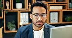 Man, reading and glasses in office with computer, research and serious consideration for investment. Investor, person and problem solving with pc, online website and decision for business venture.