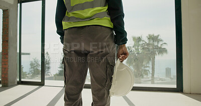 Buy stock photo Engineer, back or hand with safety helmet at construction site, development compliance or protection. PPE, legs and person with hard hat, building protocol or hazard prevention gear with risk control