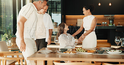 Buy stock photo Friends, greeting and chat at dinner party in home, bonding together or social gathering on weekend. Happy mature people, reunion and conversation with meal, connection and laughing on break in house
