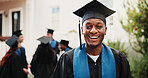 Education, man and happy on campus for graduation, degree ceremony and academic milestone. Portrait, student and smile outdoor at event for masters qualification, study achievement and graduate class