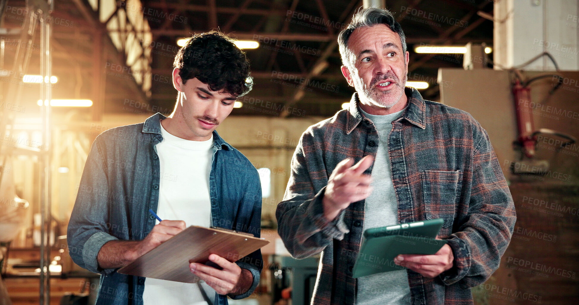 Buy stock photo Carpenter, team and writing in workshop with clipboard, tablet and mentorship for timber production. Manager, men and discussion in warehouse with tech, taking notes and advice from carpentry mentor.