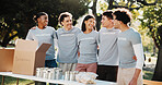 Volunteers, hug and friends with donations, outdoor and bonding together for social responsibility. People, embrace and community service at park, happiness and collaboration for nonprofit project