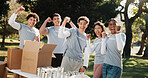 Group, volunteer and winning with success in park for outdoor outreach, donation or charity. Happy people, activist or NGO team with smile, fist pump or unity for community service or achievement